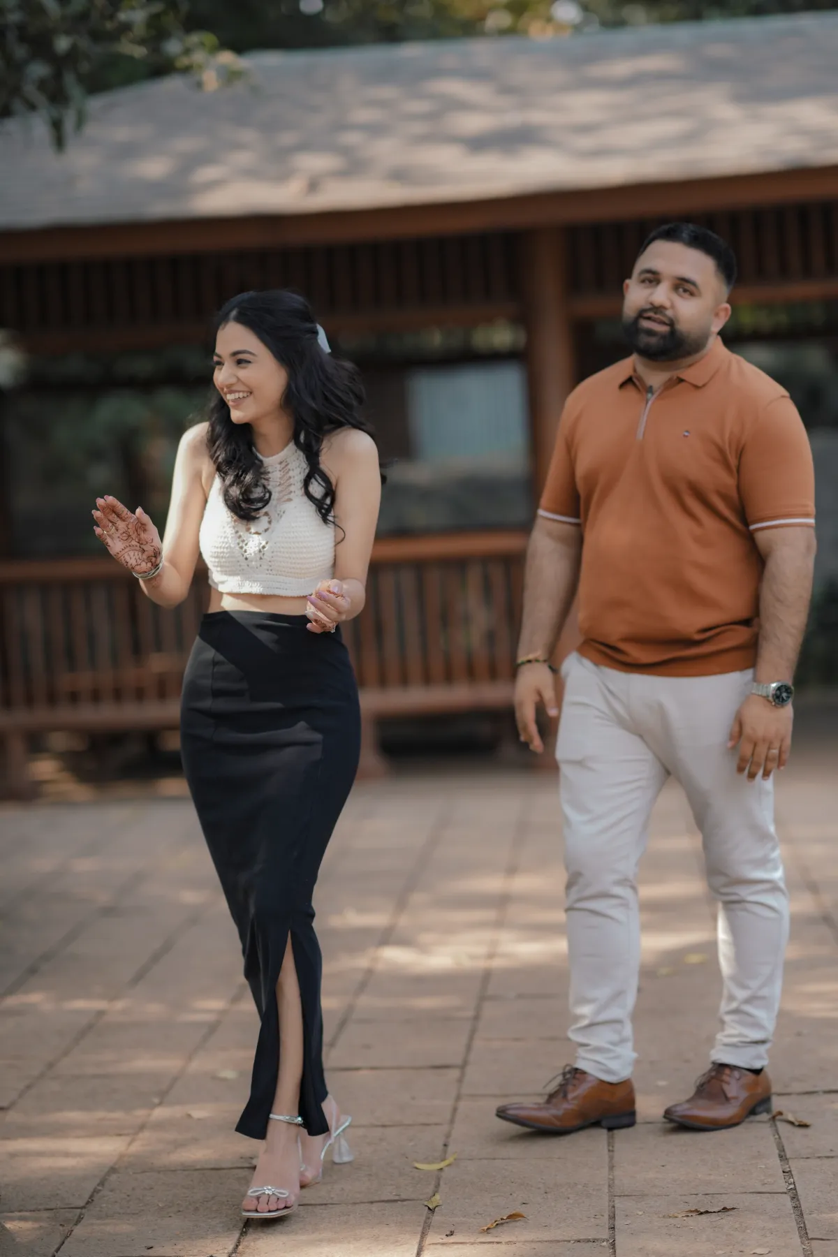 Couple walking together in garden pre wedding shoot